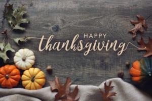 Happy Thanksgiving banner with mini pumpkins