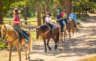 A family horseback riding in Estes Park, CO