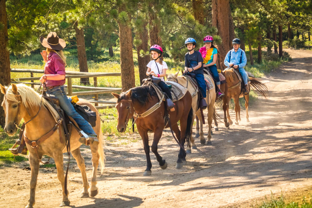 A family horseback riding in Estes Park, CO