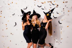 Three women in witches hats celebrating Halloween in Estes Park