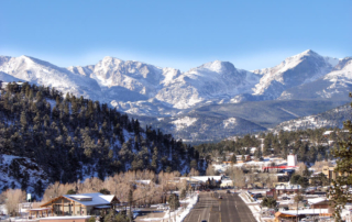 The Rocky Mountains standing tall above Estes Park, the perfect place to celebrate the holiday season in Colorado