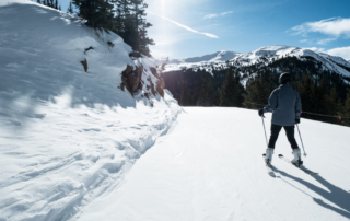 a man cross country skiing with a mountain view in snowy Estes Park