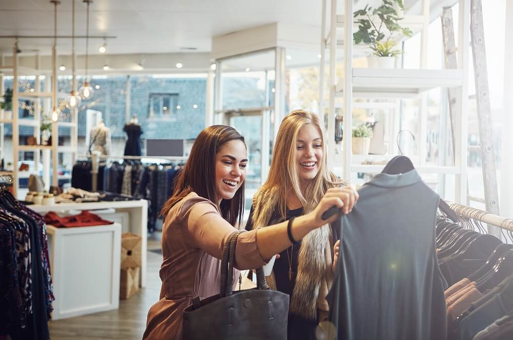 Two friends shopping for clothes at a boutique in Estes Park