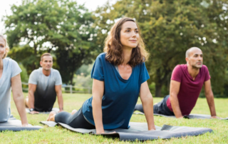 Four people enjoying an outdoor yoga class in Estes Park, CO